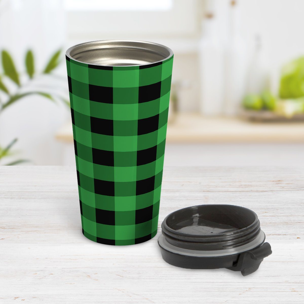 Green and Black Buffalo Plaid Travel Mug at Amy's Coffee Mugs. A travel mug designed with a black and green buffalo plaid (buffalo check) pattern that wraps around the travel mug. Photo shows the mug open on a table with its lid beside it.