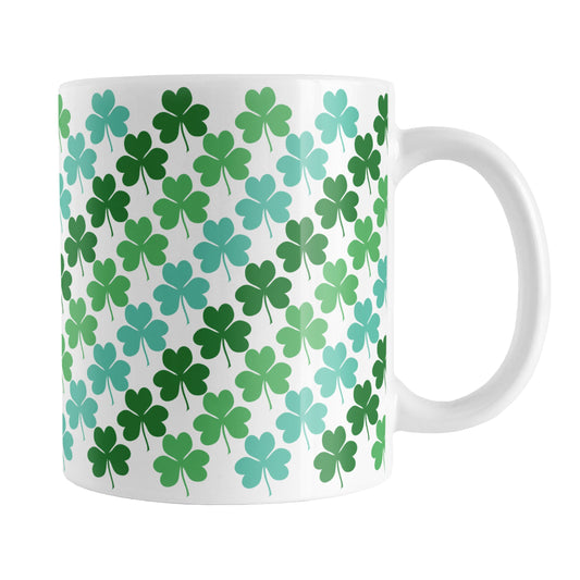 Green and Teal Clovers Mug (11oz) at Amy's Coffee Mugs. A ceramic coffee mug designed with a pattern of two-tone green and teal clovers (shamrocks) that wraps around the mug up to the handle.