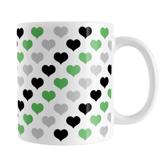 Green Black Gray Hearts Pattern Mug (11oz) at Amy's Coffee Mugs. A ceramic coffee mug designed with a pattern of hearts in black, green, and gray that wraps around the mug up to the handle.