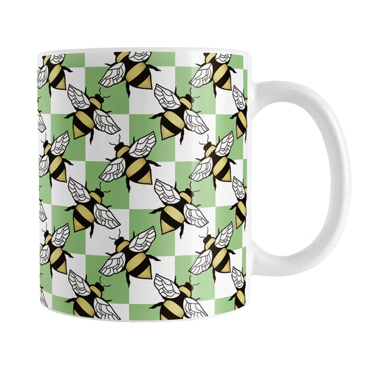 Green Checkered Bee Mug (11oz) at Amy's Coffee Mugs. A ceramic coffee mug designed with a green and white checkered pattern adorned with alternately facing bees over the check pattern. This design wraps around the mug up to the handle.