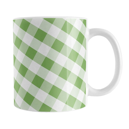 Green Gingham Mug (11oz) at Amy's Coffee Mugs. A ceramic coffee mug designed with a slanted white and green gingham pattern that wraps around the mug up to the handle.