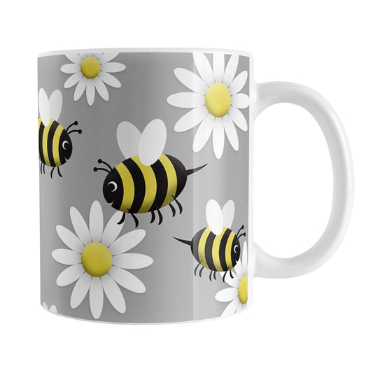 Happy Bee and Daisy Pattern Mug (11oz) at Amy's Coffee Mugs. A ceramic coffee mug designed with a cute pattern of happy bees and white daily flowers over a light gray background color that wraps around the mug up to the handle.