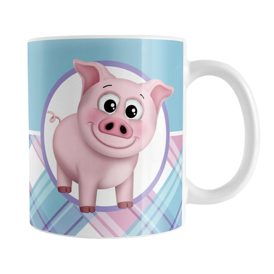 Happy Pink Pig with Plaid Pattern Mug (11oz) at Amy's Coffee Mugs. A ceramic coffee mug designed with an adorable and happy pink pig in a white circle on both sides of the mug over a background pattern that wraps around the mug up to the handle with a solid blue color along the top half and a pink, purple, and blue plaid pattern along the bottom half.
