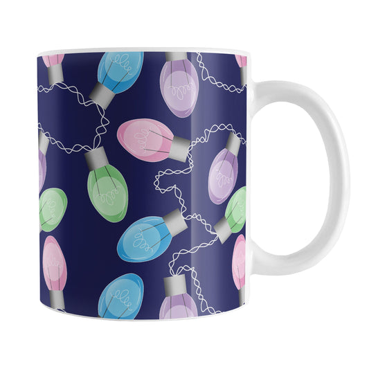 Holiday Lights Pattern Christmas Mug (11oz) at Amy's Coffee Mugs. A ceramic coffee mug designed with string of colorful holiday lights in pink, blue, green, and purple in a pattern over a navy blue background color that wraps around the mug up to the handle.