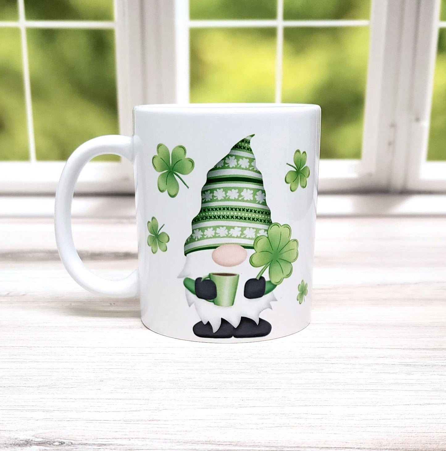Lucky Clover Gnome Mug (11oz) in front of a spring window view.