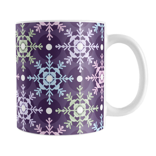 Pastel Winter Argyle Snowflake Pattern Mug (11oz) at Amy's Coffee Mugs. A ceramic coffee mug designed with a pattern of pastel snowflakes in pink, blue, green, and purple geometrically arranged in an argyle appearance over a deep purple background color that wraps around the mug up to the handle.