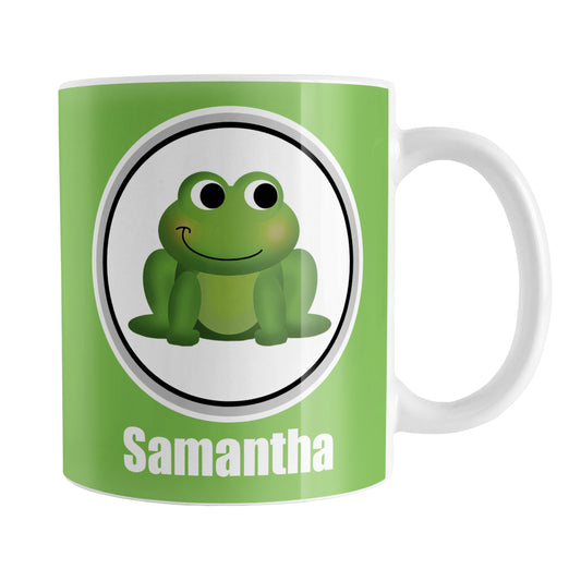 Personalized Adorable Green Frog Mug (11oz) at Amy's Coffee Mugs. A ceramic coffee mug designed with a cute and happy green frog in a white circle on both sides of the mug over a green background color that wraps around the mug up to the handle. Your name is custom-printed in white below the adorable frog.