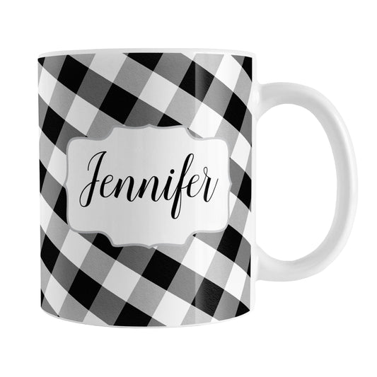 Personalized Black and White Gingham Mug (11oz) at Amy's Coffee Mugs. A ceramic coffee mug designed with a slanted black and white gingham pattern that wraps around the mug to the handle. Your name is printed in a pretty black script font in a white frame design on both sides of the mug over the gingham pattern.