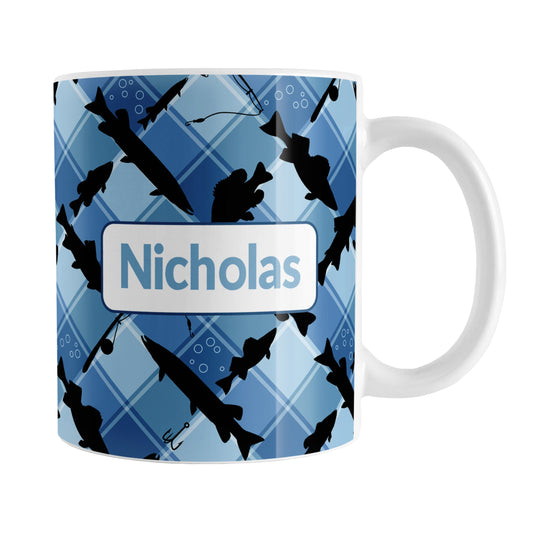 Personalized Blue Fishing Plaid Pattern Mug (11oz) at Amy's Coffee Mugs. A ceramic coffee mug designed with black silhouettes of fish, fishing poles, and lures diagonally arranged over a blue plaid pattern that wraps around the mug up to the handle. Your name is printed in blue in a white frame design on both sides of the mug over the fishing pattern.