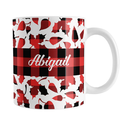 Personalized Buffalo Plaid Leaves Fall Mug (11oz) at Amy's Coffee Mugs. A ceramic coffee mug designed with a pattern of leaves with a red and black buffalo plaid pattern that wraps around the mug to the handle. There is a buffalo plaid stripe across the center over the leaves with your name custom printed in a white script font on both sides of the mug.