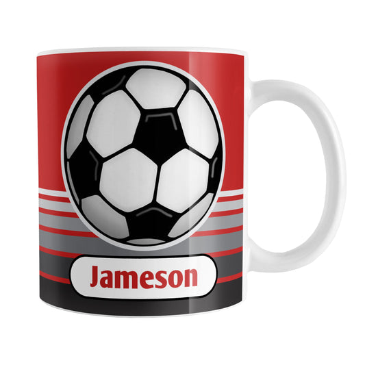 Personalized Gray Gradient Lined Red Soccer Ball Mug (11oz) at Amy's Coffee Mugs. A ceramic coffee mug designed with a big soccer ball on both sides of the mug over gradient black to gray lines along the bottom over a red background color that wraps around the mug up to the handle. Your personalized name is printed in red below the soccer ball.