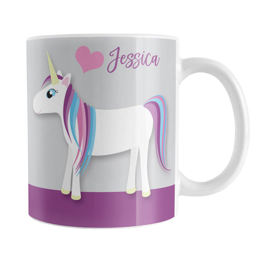 Personalized Happy Pink Heart Purple Unicorn Mug (11oz) at Amy's Coffee Mugs. A ceramic coffee mug designed with a happy unicorn with a pink, blue, and purple mane and a pink heart above it over a purple and gray background that wraps around the mug up to the handle. Your personalized name is custom printed in a cute purple font above the unicorn next to the pink heart.