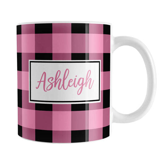 Personalized Name Light Pink and Black Buffalo Plaid Mug (11oz) at Amy's Coffee Mugs. A ceramic coffee mug designed with a black and light pink buffalo plaid (buffalo check) pattern that wraps around the mug up to the handle. Your name is custom printed in pink inside a white frame design on both sides of the mug over the buffalo plaid pattern.