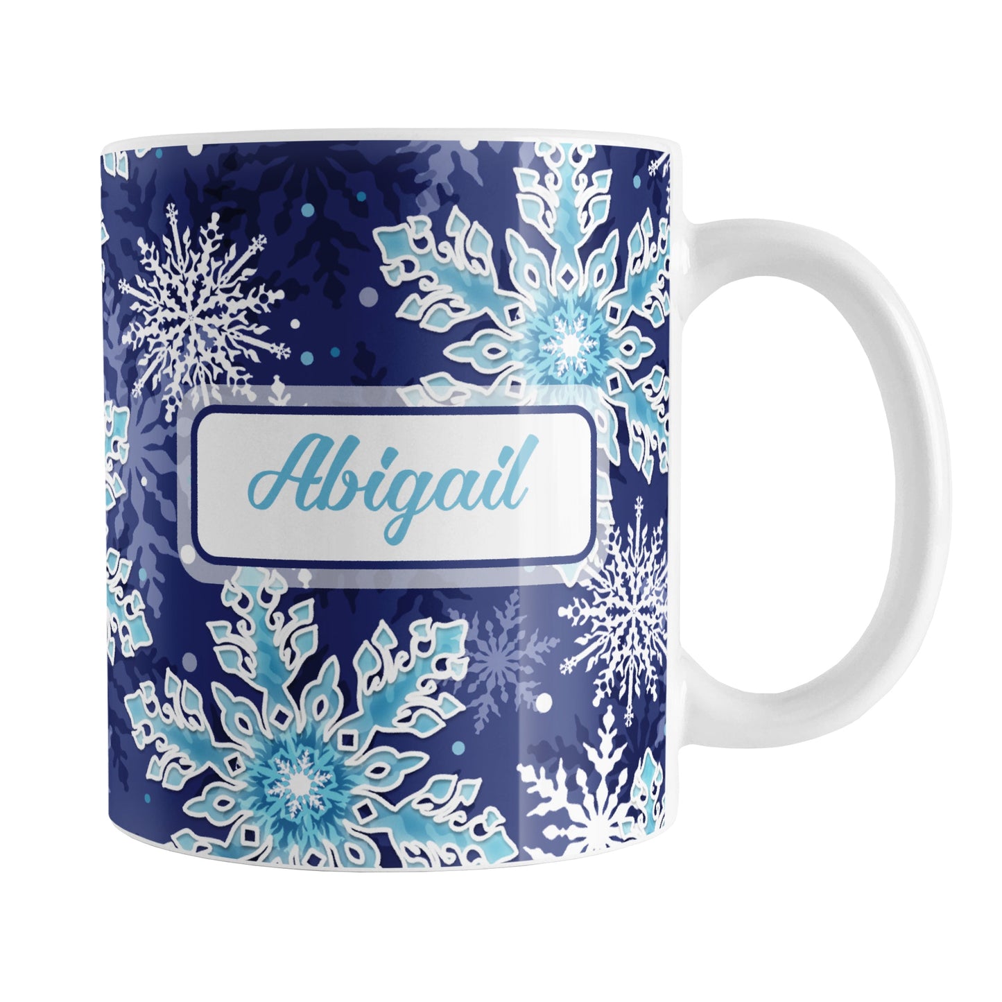 Personalized Navy Blue Aqua Snowflake Winter Mug (11oz) at Amy's Coffee Mugs. A ceramic coffee mug designed with a pattern of aqua blue and white snowflakes over a navy blue background color that wraps around the mug to the handle. Your name is personalized in blue in a white frame design on both sides of the mug over the snowflakes pattern.