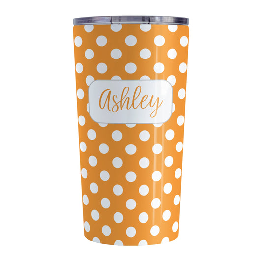 Personalized Orange Polka Dot Tumbler Cup (20oz, stainless steel insulated) at Amy's Coffee Mugs. A tumbler cup designed with a pattern of white polka dots over an orange background color that wraps around the cup. Your name is personalized in a cute orange script font in a white frame design over the polka dot pattern.