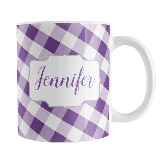 Personalized Purple Gingham Mug (11oz) at Amy's Coffee Mugs. A ceramic coffee mug designed with a slanted purple and white gingham pattern that wraps around the mug up to the handle. Your personalized name is custom-printed in a purple script font on both sides of the mug over the gingham pattern.