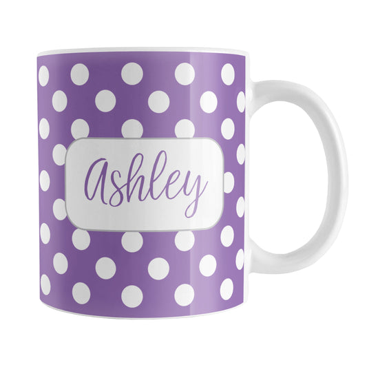 Personalized Purple Polka Dot Mug (11oz) at Amy's Coffee Mugs. A ceramic coffee mug designed with a pattern of white polka dots over a purple background color that wraps around the mug up to the handle. Your name is personalized in a cute purple script font in a white frame design on both sides of the mug over the polka dot pattern.