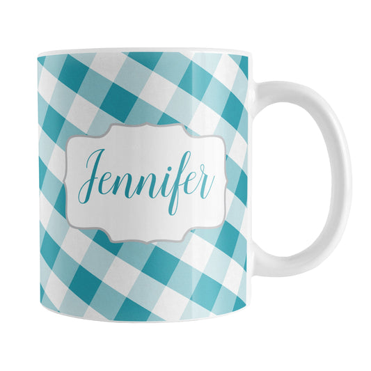 Personalized Turquoise Gingham Mug (11oz) at Amy's Coffee Mugs. A ceramic coffee mug designed with a slanted turquoise and white gingham pattern that wraps around the mug up to the handle. Your personalized name is custom-printed in a turquoise script font on both sides of the mug over the gingham pattern.