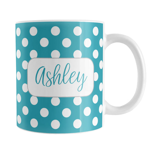 Personalized Turquoise Polka Dot Mug (11oz) at Amy's Coffee Mugs. A ceramic coffee mug designed with a pattern of white polka dots over a turquoise background color that wraps around the mug up to the handle. Your name is personalized in a cute turquoise script font in a white frame design on both sides of the mug over the polka dot pattern.