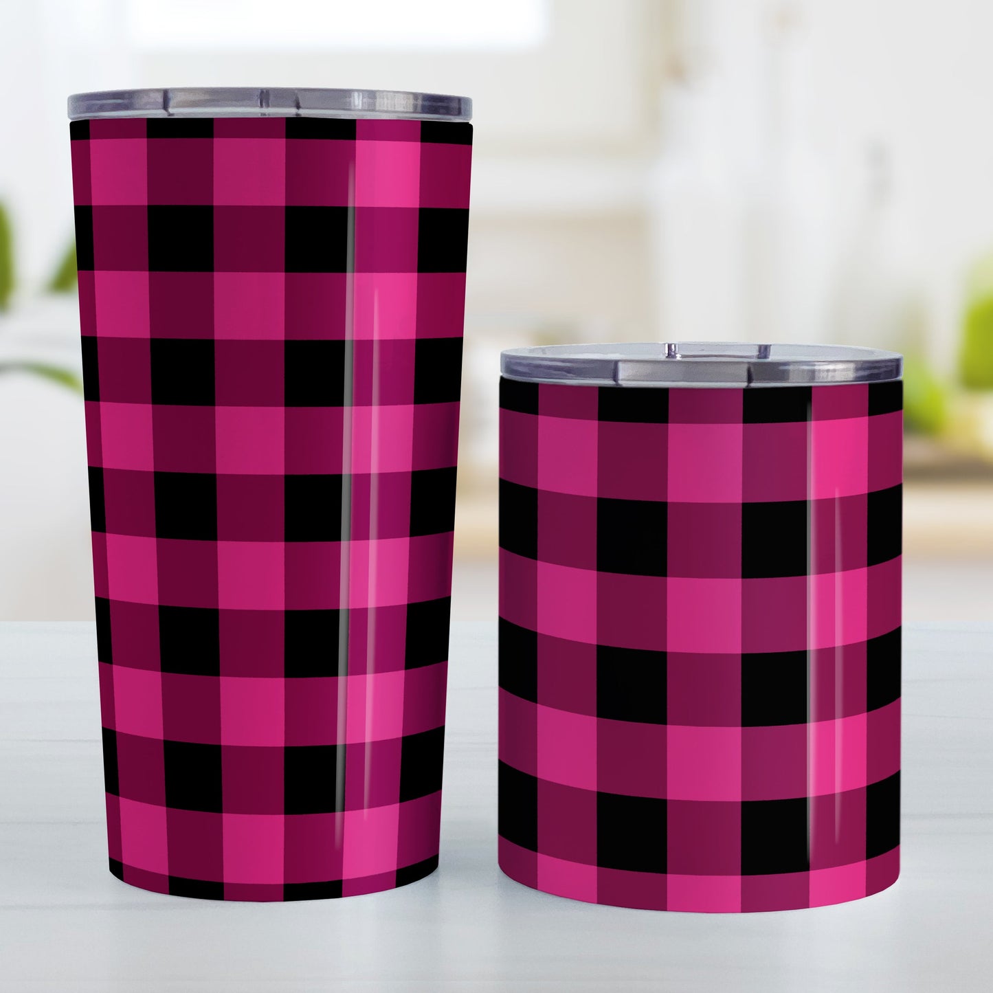 Pink and Black Buffalo Plaid Tumbler Cup (20oz and 10oz, stainless steel insulated) at Amy's Coffee Mugs. A tumbler cup designed with a dark raspberry pink and black buffalo plaid pattern that wraps around the cup. Photo shows both sized cups on a table next to each other.