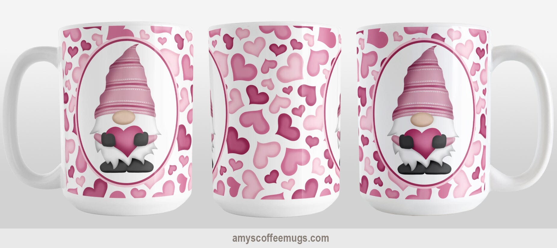Pink Gnome Hearts Mug (15oz) at Amy's Coffee Mugs. A ceramic coffee mug designed with an adorable pink gnome in a white oval on both sides of the mug over a pattern of cute hearts in different shades of pink that wrap around the mug to the handle. The photo shows 3 sides of the mug design.