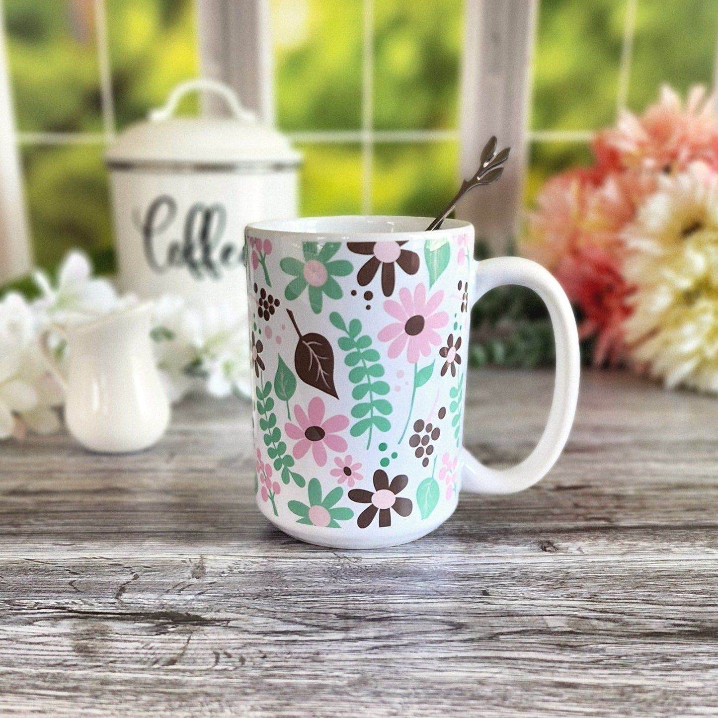 Pink Green Brown Floral Pattern Mug (15oz, in rustic kitchen scene) at Amy's Coffee Mugs. A ceramic coffee mug designed with flowers and leaves in pink, green, and brown in a pretty floral pattern that wraps around the mug up to the handle.