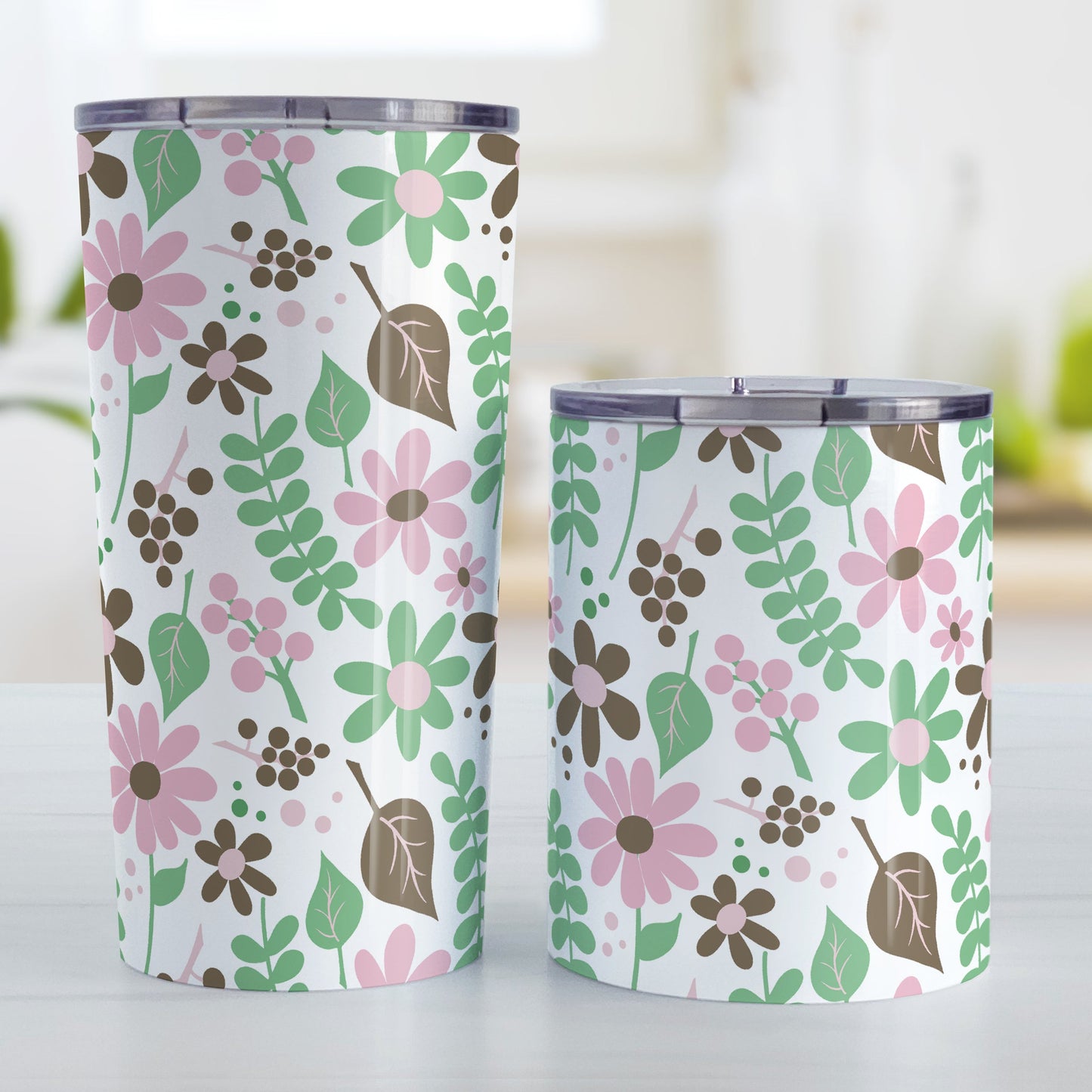 Pink Green Brown Floral Pattern Tumbler Cup (20oz on 10oz, stainless steel insulated) at Amy's Coffee Mugs. A tumbler cup designed with flowers and leaves in pink, green, and brown in a pretty floral pattern that wraps around the cup. Photo shows both sized cups on a table next to each other.
