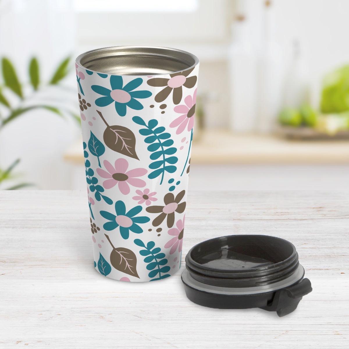 Pink Turquoise Brown Floral Pattern Travel Mug (15oz) at Amy's Coffee Mugs. A travel mug designed with a pretty flowers and leaves pattern in pink, dark turquoise, and brown that wraps around the mug. Photo shows the mug open in a table with its lid beside it.