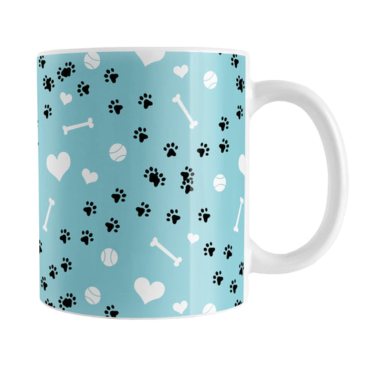 Puppy Run Blue Dog Mug (11oz) at Amy's Coffee Mugs. A ceramic coffee mug designed with a pattern of chaotic tracks of puppy paw prints running around the mug with white dog bones, balls, and hearts over a light blue background. This mug is perfect for people who love the chaotic play of puppies, love dogs, and like blue mugs.