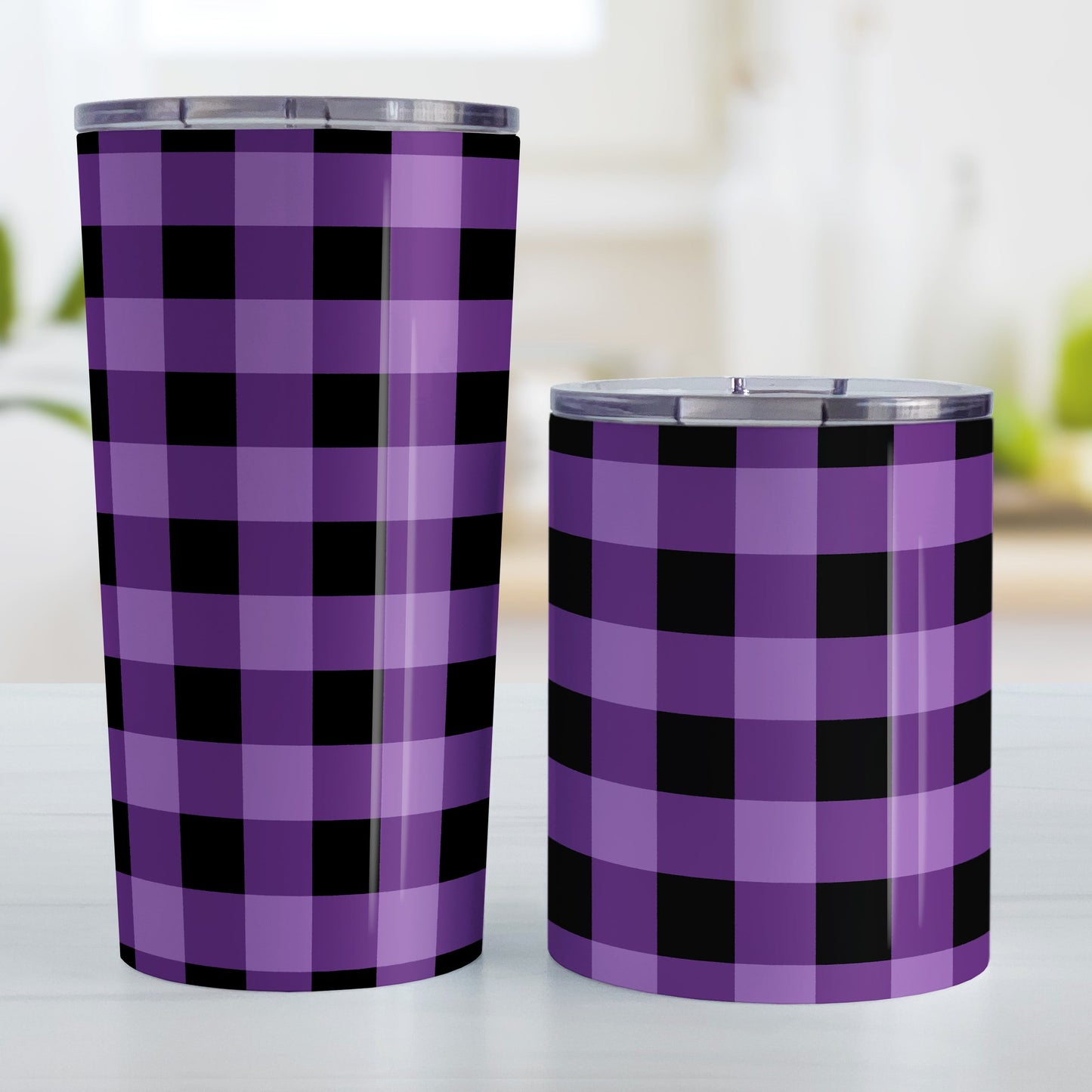 Purple and Black Buffalo Plaid Tumbler Cup (20oz and 10oz, stainless steel insulated) at Amy's Coffee Mugs. A tumbler cup designed with a purple and black buffalo plaid (buffalo check) pattern that wraps around the cup. Photo shows both sized cups on a table next to each other.