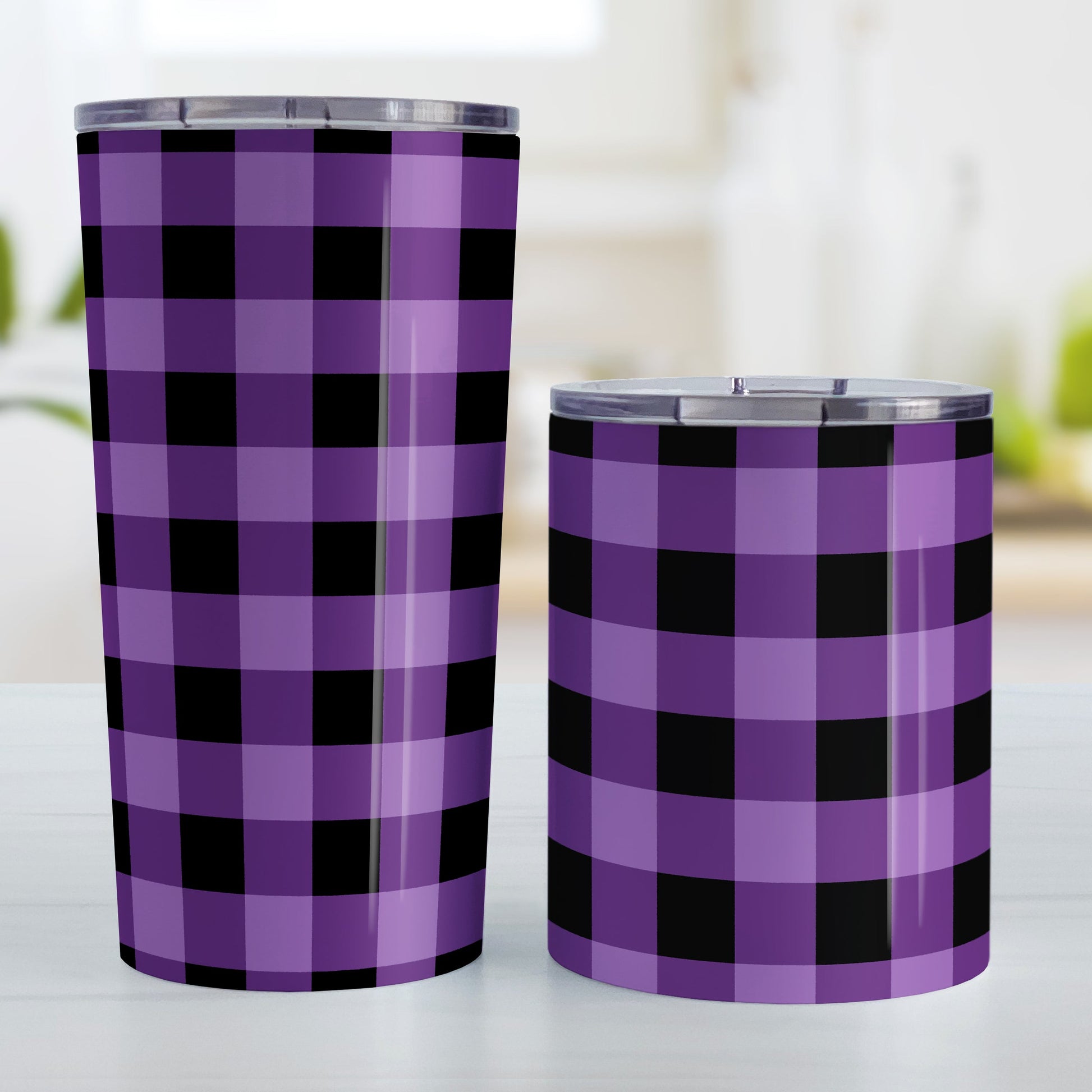 Purple and Black Buffalo Plaid Tumbler Cup (20oz and 10oz, stainless steel insulated) at Amy's Coffee Mugs. A tumbler cup designed with a purple and black buffalo plaid (buffalo check) pattern that wraps around the cup. Photo shows both sized cups on a table next to each other.