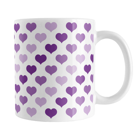 Purple Hearts Pattern Mug (11oz) at Amy's Coffee Mugs. A ceramic coffee mug designed with a pattern of hearts in three different shades of purple that wraps around the mug up to the handle.