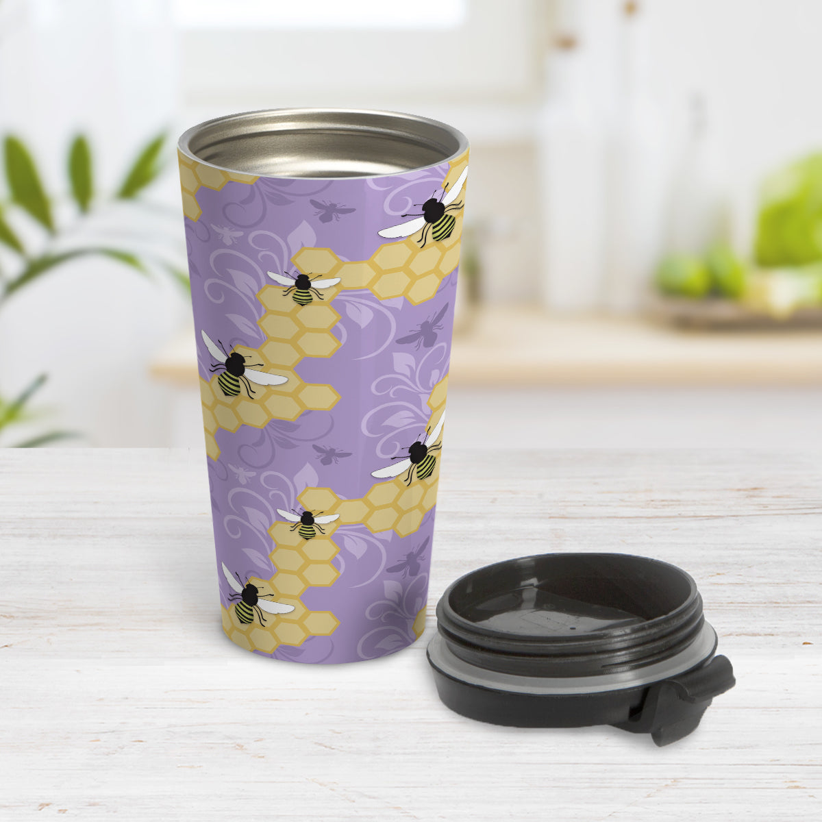 Purple Honeycomb Bee Travel Mug (15oz) at Amy's Coffee Mugs. A travel mug designed with a pattern of black and yellow bees on honeycomb lines over a purple flourish background that wraps around the tapered shaped mug.