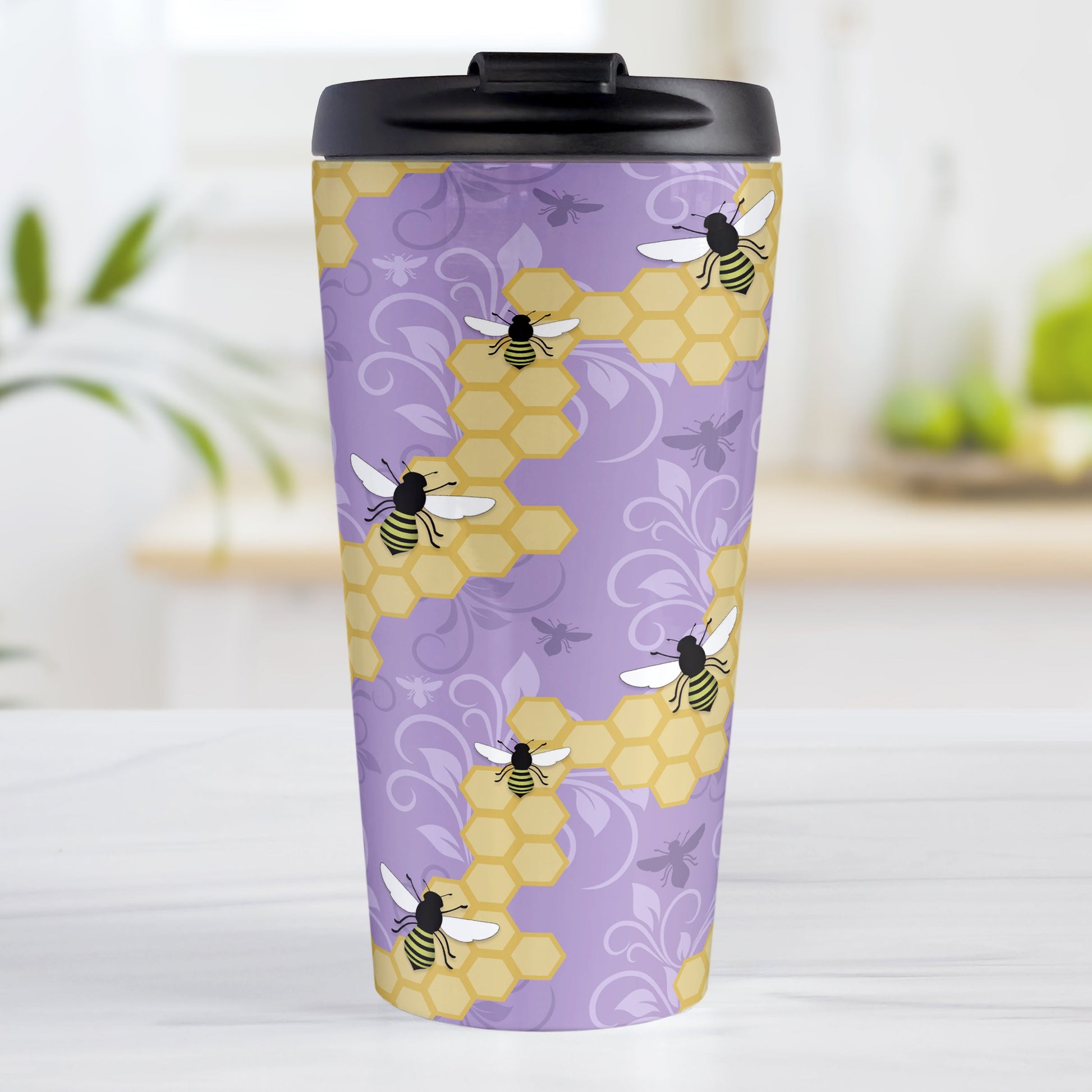 Purple Honeycomb Bee Travel Mug (15oz, stainless steel insulated) at Amy's Coffee Mugs. A travel mug designed with a pattern of black and yellow bees on honeycomb lines over a purple flourish background that wraps around the tapered shaped mug.