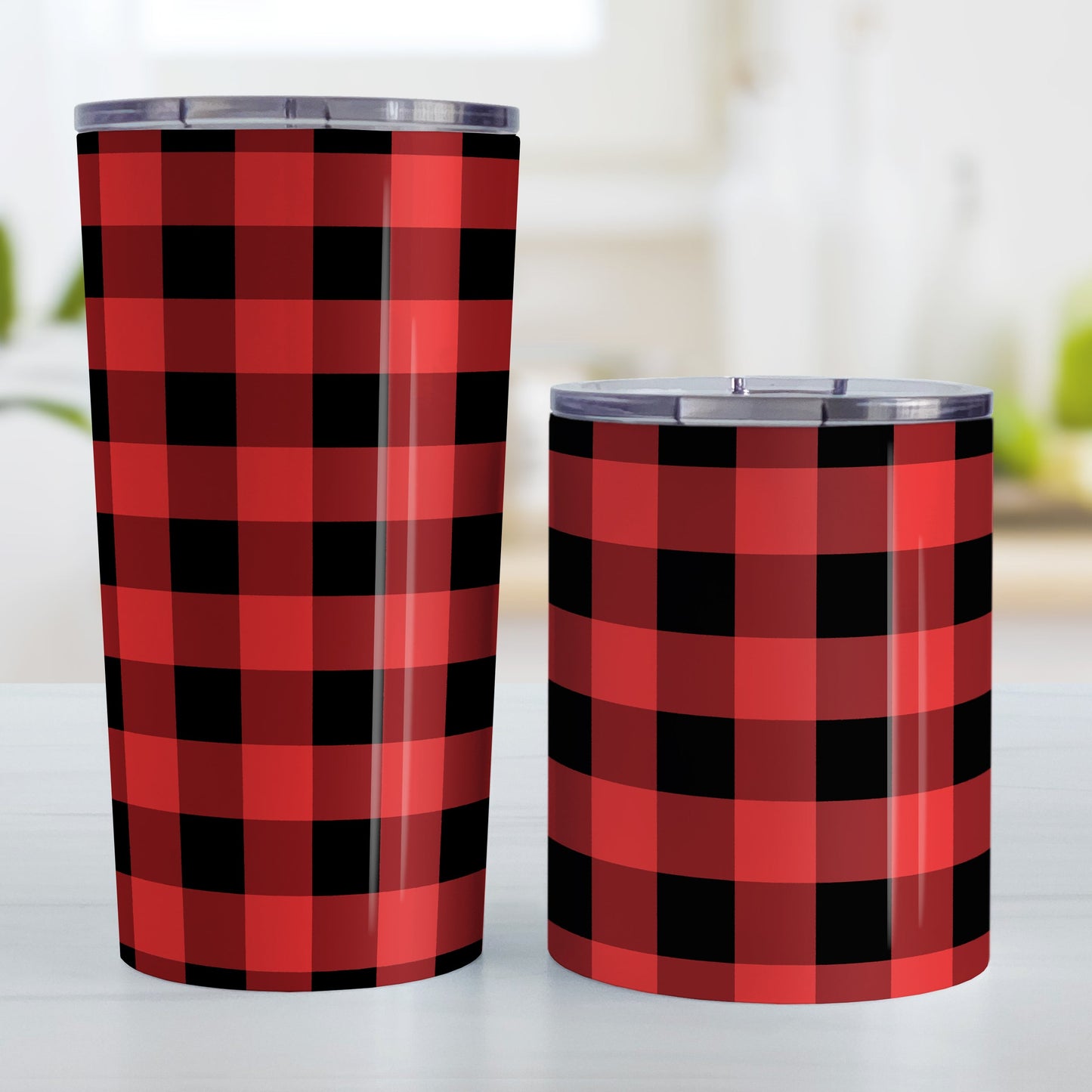 Red and Black Buffalo Plaid Tumbler Cup (20oz and 10oz, stainless steel insulated) at Amy's Coffee Mugs. A tumbler cup designed with a red and black buffalo plaid (buffalo check) pattern that wraps around the cup. Photo shows both sized cups on a table next to each other.