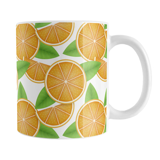 Sliced Oranges Mug (11oz) at Amy's Coffee Mugs. A ceramic coffee mug designed with an illustration of sliced oranges in halves and wedges with green leaves in a pattern that wraps around the mug to the handle.