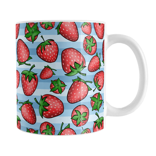 Strawberries on Blue Stripes Mug (11oz) at Amy's Coffee Mugs. A ceramic mug featuring a print of hand-drawn strawberries in red and green in an assorted pattern over a blue stripes background that wraps around the mug up to the handle.