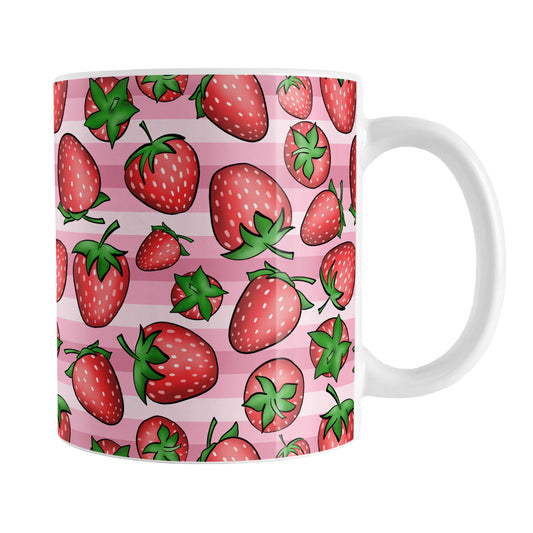 Strawberries on Pink Stripes Mug (11oz) at Amy's Coffee Mugs. A ceramic coffee mug featuring a print of hand-drawn strawberries in red and green in an assorted pattern over a pink stripes background that wraps around the mug up to the handle.