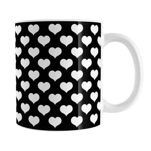 White Hearts Pattern Black Mug (11oz) at Amy's Coffee Mugs. A ceramic coffee mug designed with white hearts in a polka-dotted pattern over a black background color that wraps around the mug up to the handle.