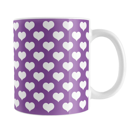 White Hearts Pattern Purple Mug (11oz) at Amy's Coffee Mugs. A ceramic coffee mug designed with white hearts in a polka-dotted style pattern over a purple background color that wraps around the mug up to the handle.