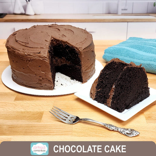 Chocolate cake and cake slice in kitchen background - Amy's Coffee Mugs