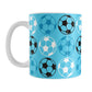 An 11oz white mug with a blue soccer pattern, over a white background