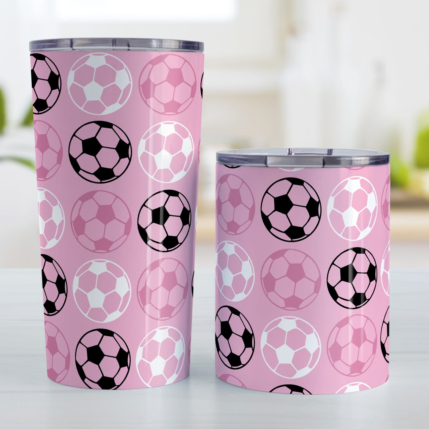 Alternating Pink Soccer Balls Tumbler Cup at Amy's Coffee Mugs. Photo shows both sized cups next to each other.