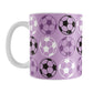 An 11oz white mug with a purple soccer ball pattern, over a white background