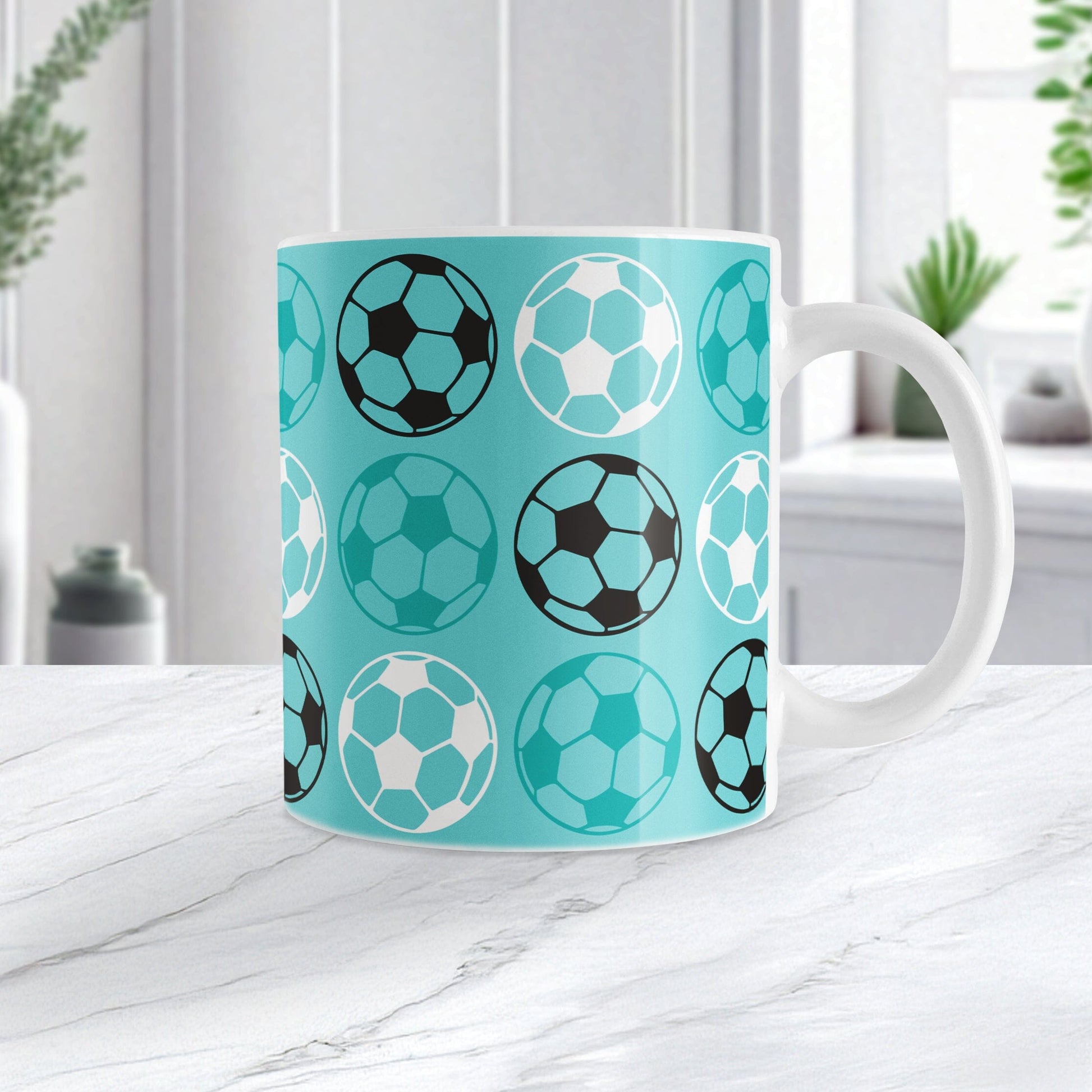 11oz white mug with a light teal soccer ball pattern, on a marble tabletop