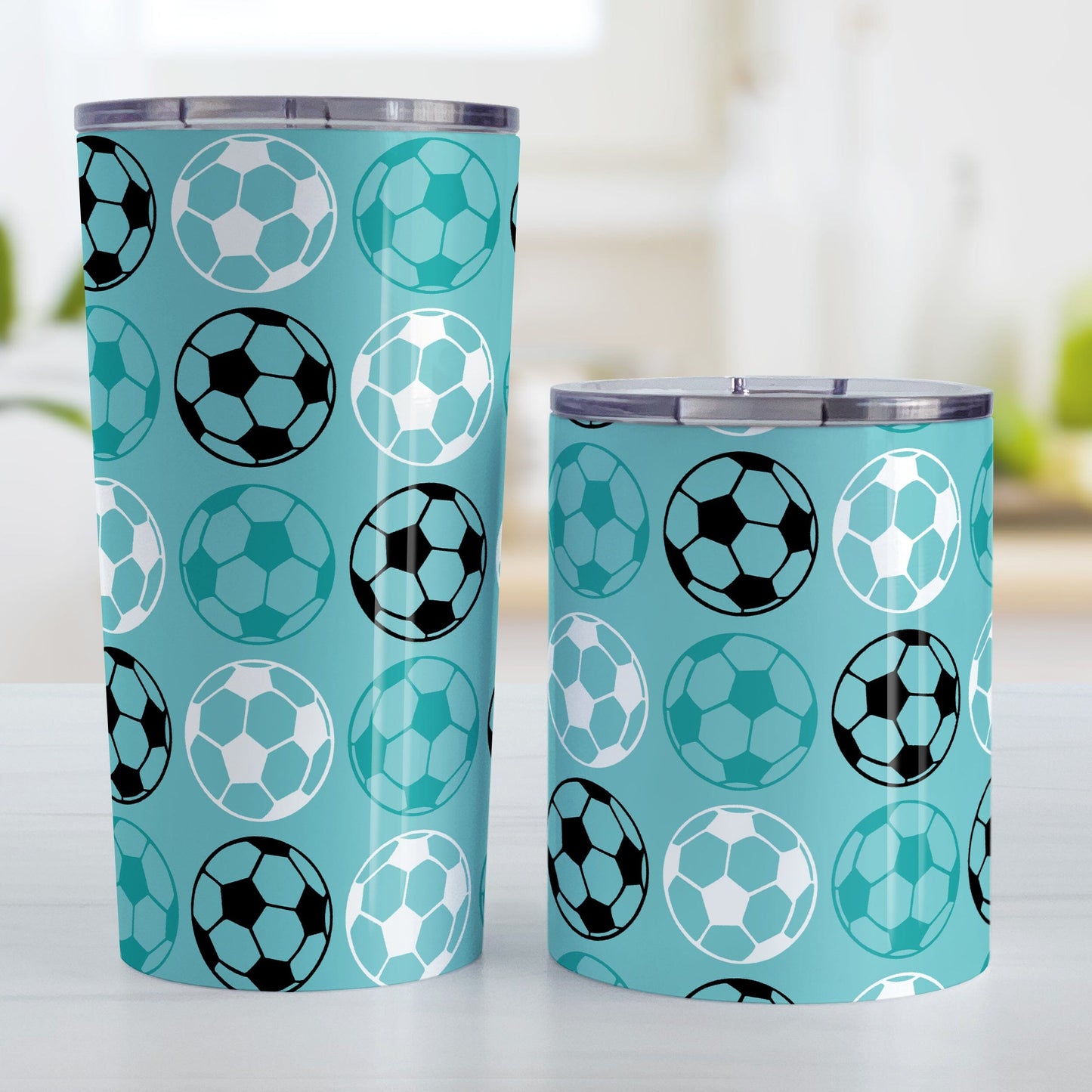 Alternating Teal Soccer Balls Tumbler Cup at Amy's Coffee Mugs. Photo shows both sized cups next to each other.