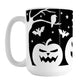 Black and White Halloween Mug (15oz) at Amy's Coffee Mugs. A ceramic coffee mug designed with white silhouette pumpkin jack o'lanterns, bats, stars and a raven in each leafless tree along each side of the design in a spooky scene over a black background that wraps around the mug up to the handle.