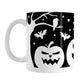 Black and White Halloween Mug (11oz) at Amy's Coffee Mugs. A ceramic coffee mug designed with white silhouette pumpkin jack o'lanterns, bats, stars and a raven in each leafless tree along each side of the design in a spooky scene over a black background that wraps around the mug up to the handle.