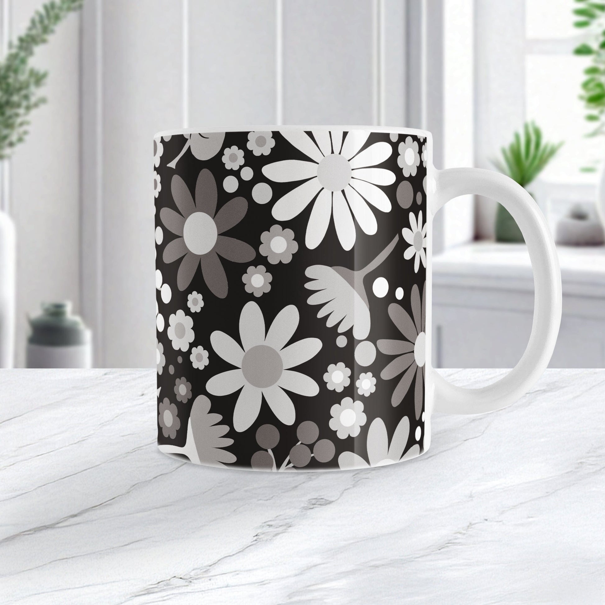 Mug with a floral pattern featuring white and gray flowers on a black background, set on a marble countertop