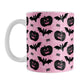 Black Pumpkins Bats and Spiders Pink Halloween Mug (11oz) at Amy's Coffee Mugs. A ceramic coffee mug designed with a pattern of black carved pumpkins, bats, and spiders in their webs in a pattern over a pink background color that wraps around the mug up to the handle.